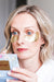 model wearing golden under eye patches from wander beauty