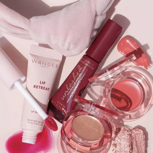 Wander Beauty Makeup and Skincare Products on a pink background