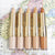 various shades of the wander beauty dualist matte & illuminating concealer laid on a map