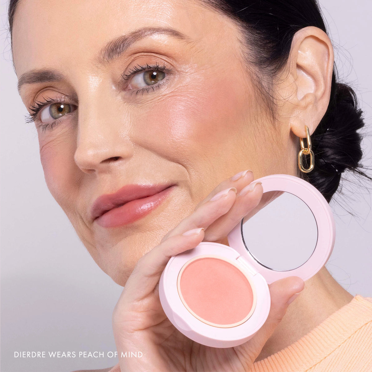 Model wearing Blush All Day Hydrating Powder Blush in Peach of Mind