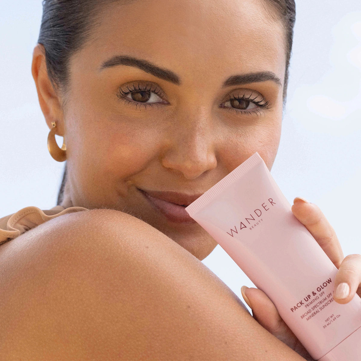 Model wearing Pack Up & Glow Priming Mineral SPF 40