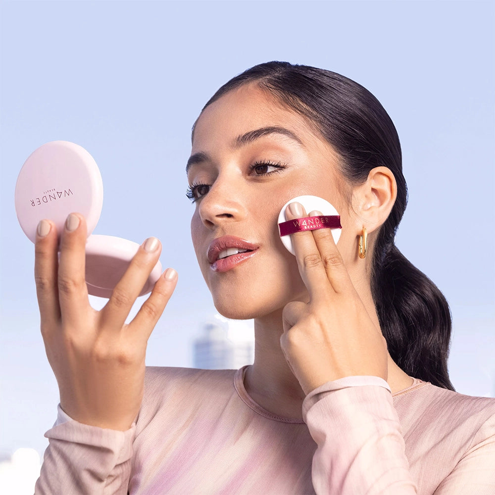 Model applying Wanderlust Powder Foundation