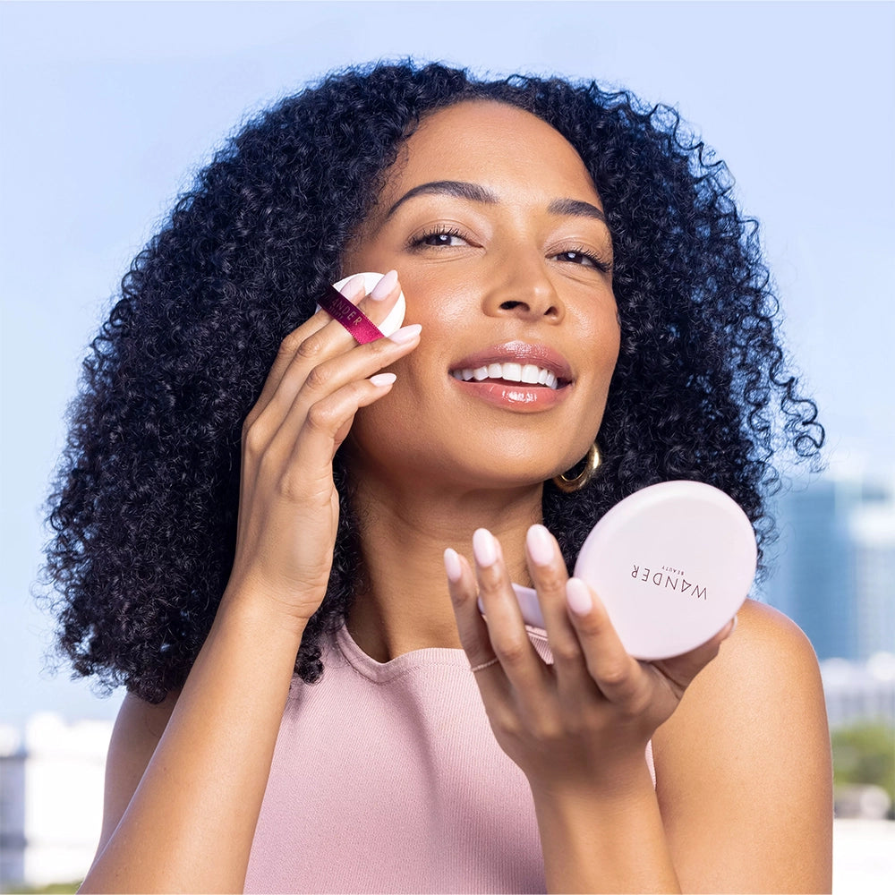 Model applying Wanderlust Powder Foundation